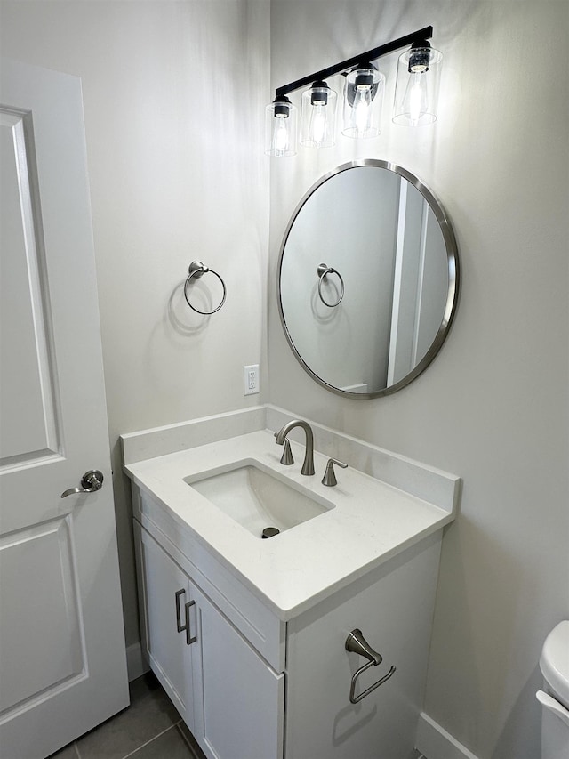 bathroom with vanity, toilet, and tile patterned flooring