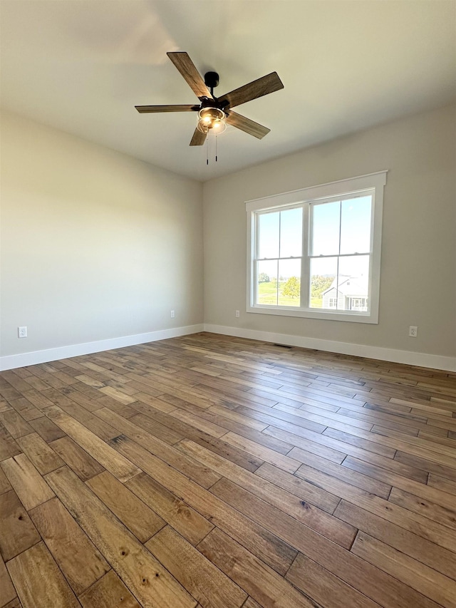 empty room with wood-type flooring and ceiling fan