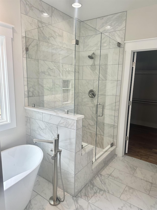 bathroom featuring separate shower and tub