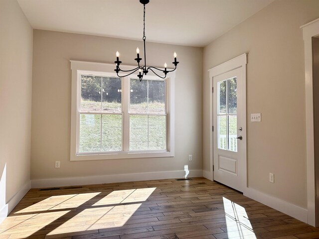 interior space featuring wood-type flooring and a notable chandelier