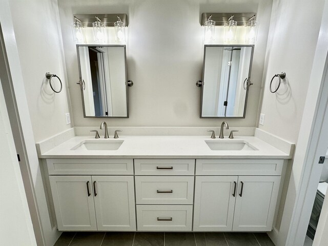 bathroom with vanity, tile patterned floors, and toilet