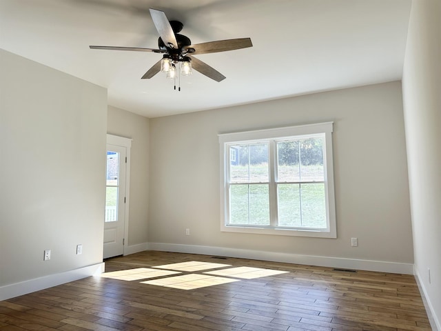 spare room featuring hardwood / wood-style flooring and ceiling fan