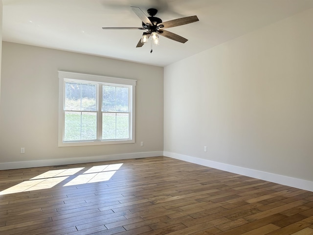 empty room with ceiling fan and wood-type flooring