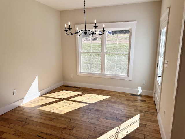 interior space with an inviting chandelier and hardwood / wood-style floors