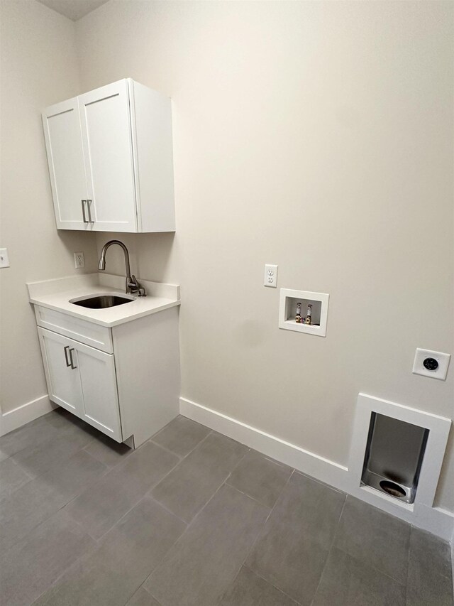 laundry area with sink, cabinets, washer hookup, electric dryer hookup, and tile patterned floors