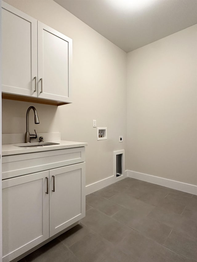 laundry room with electric dryer hookup, sink, hookup for a washing machine, and cabinets