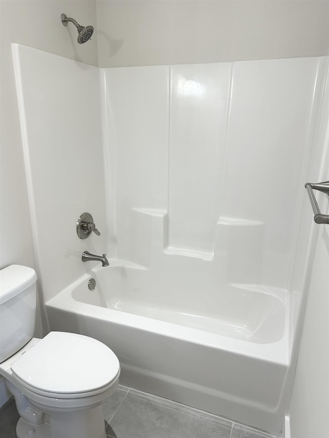 bathroom with tile patterned floors, toilet, and tub / shower combination