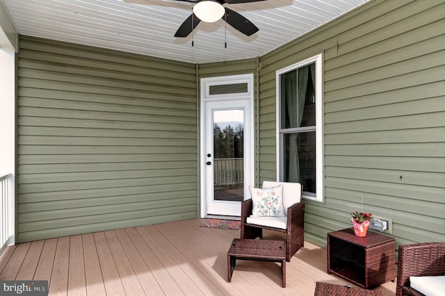 wooden terrace with a ceiling fan