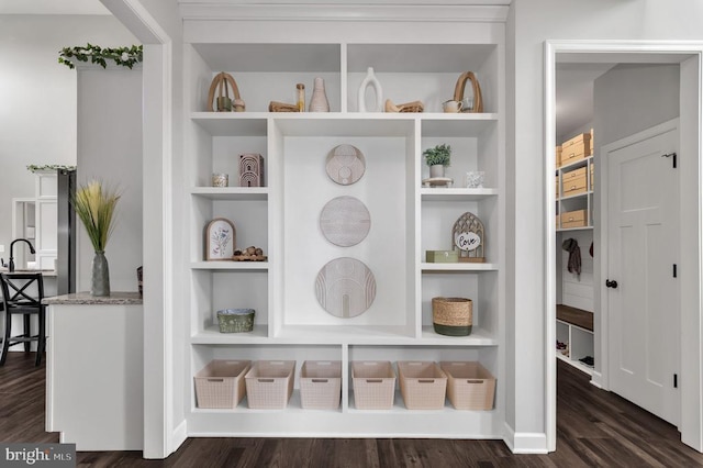 room details with built in shelves, wood finished floors, and baseboards