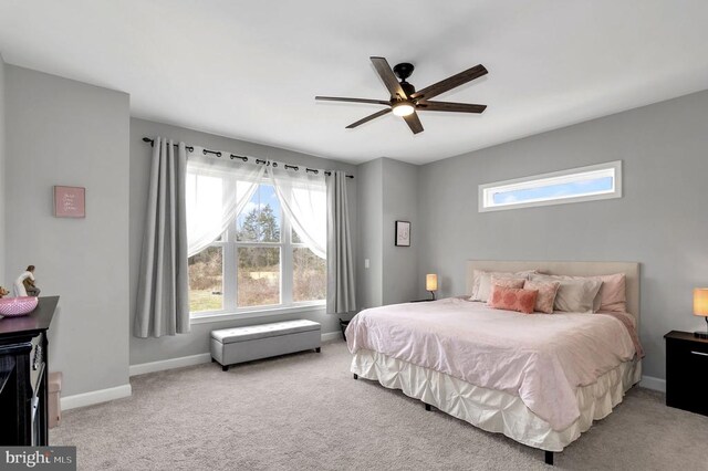 bedroom featuring carpet flooring, a ceiling fan, and baseboards