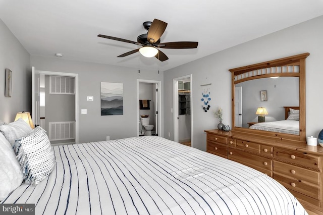 bedroom featuring a closet, visible vents, a walk in closet, and ceiling fan