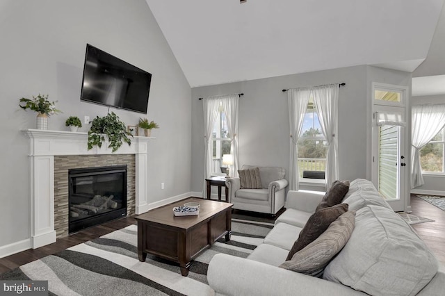 living area featuring wood finished floors, baseboards, and a wealth of natural light