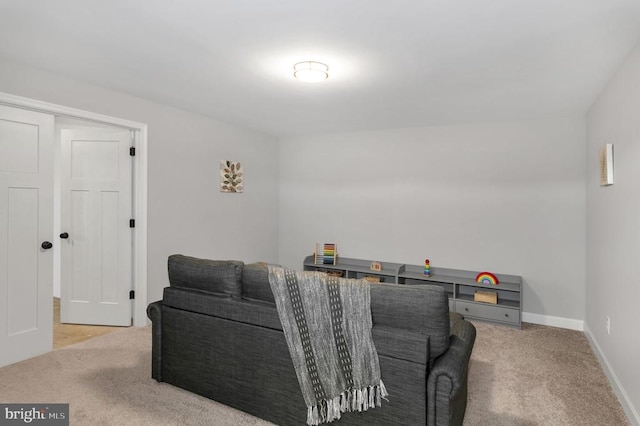 carpeted living room featuring baseboards