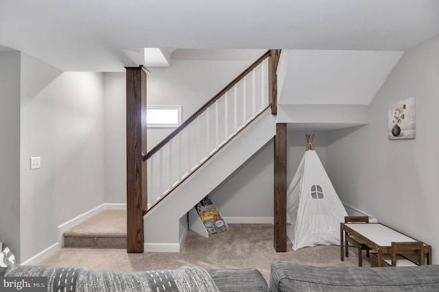 stairway with vaulted ceiling, baseboards, and carpet floors