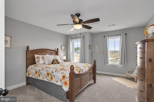 carpeted bedroom featuring visible vents, ceiling fan, and baseboards