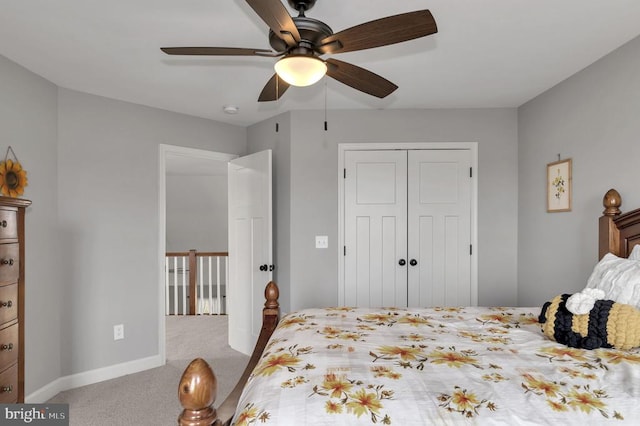 bedroom featuring a closet, carpet floors, baseboards, and a ceiling fan