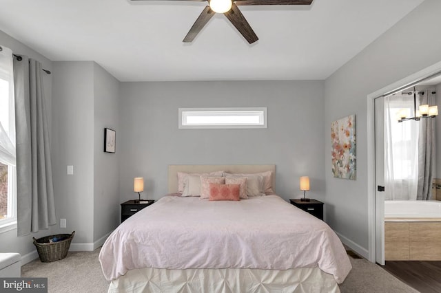 bedroom featuring ensuite bath, baseboards, carpet floors, and ceiling fan