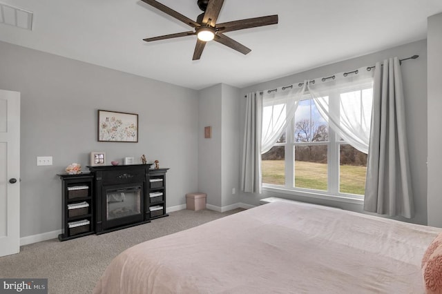 bedroom featuring visible vents, carpet flooring, a ceiling fan, and baseboards