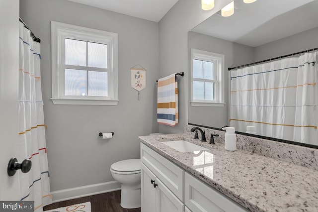 bathroom with vanity, a shower with curtain, wood finished floors, baseboards, and toilet