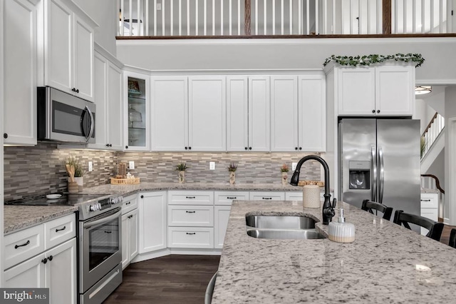 kitchen featuring a sink, white cabinets, and stainless steel appliances