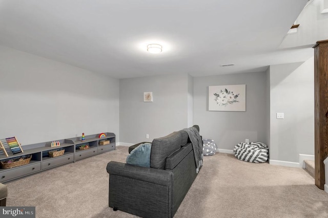 carpeted living room featuring baseboards and visible vents