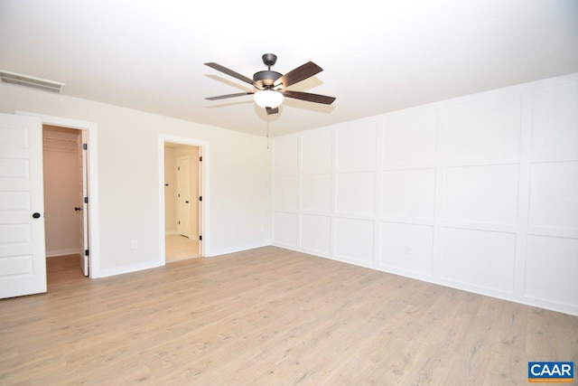 unfurnished room with ceiling fan and light hardwood / wood-style floors