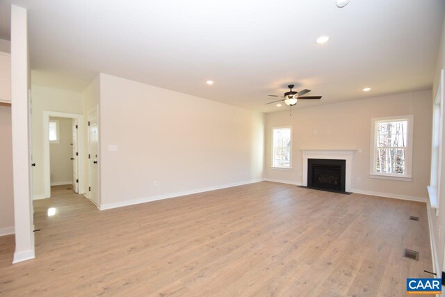 unfurnished living room with ceiling fan and light hardwood / wood-style floors