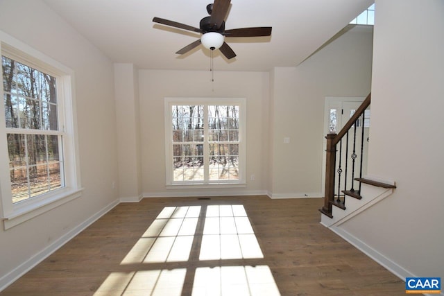 interior space with ceiling fan and dark hardwood / wood-style floors