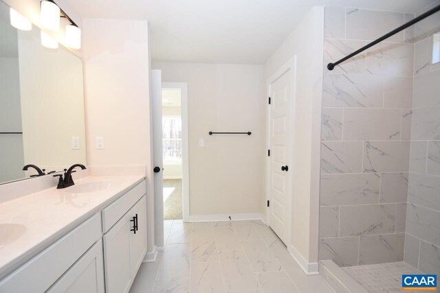 bathroom featuring vanity and tiled shower