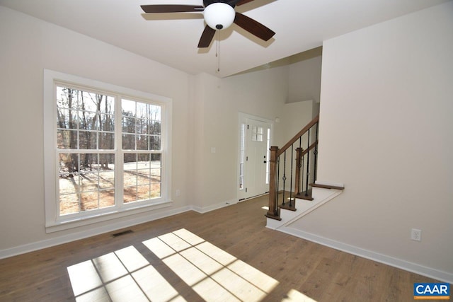 foyer with dark wood-type flooring and ceiling fan