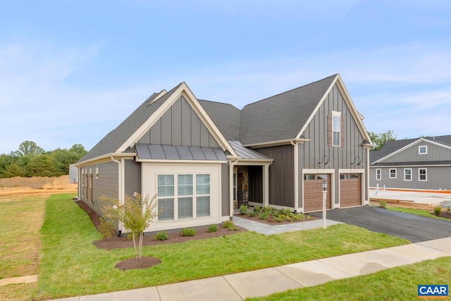 view of front of house with a garage and a front yard