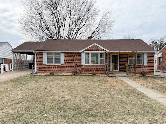 view of front facade featuring a carport and a front yard