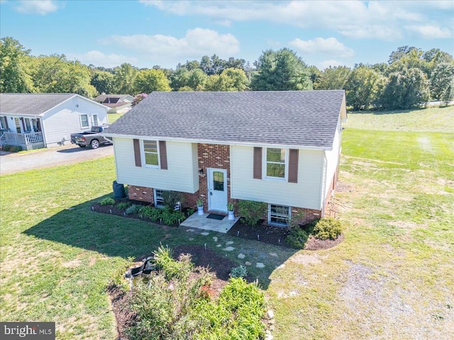 bi-level home with a front lawn