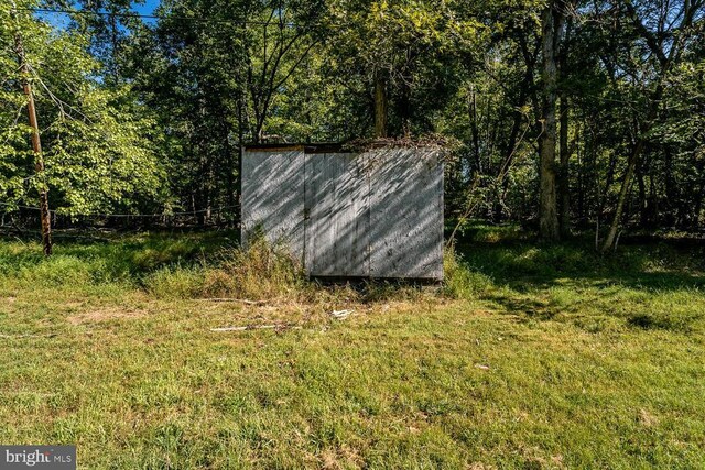 view of outbuilding with a lawn