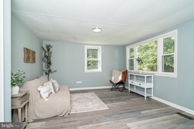 sitting room featuring a paneled ceiling and hardwood / wood-style floors