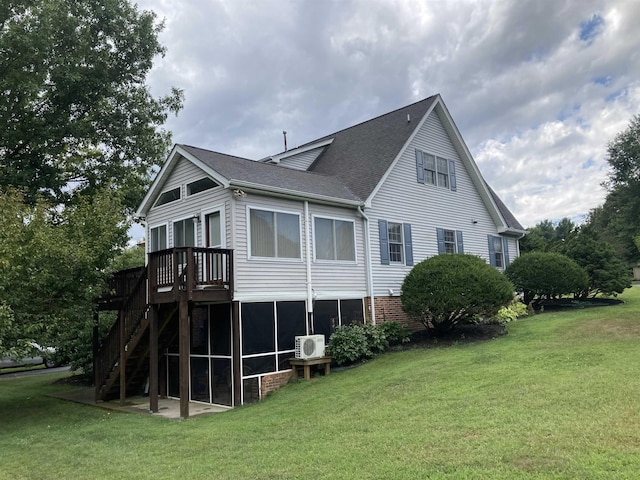 rear view of property featuring ac unit, stairs, a lawn, and roof with shingles