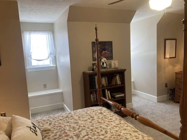 bedroom featuring a ceiling fan, carpet, baseboards, and a textured ceiling