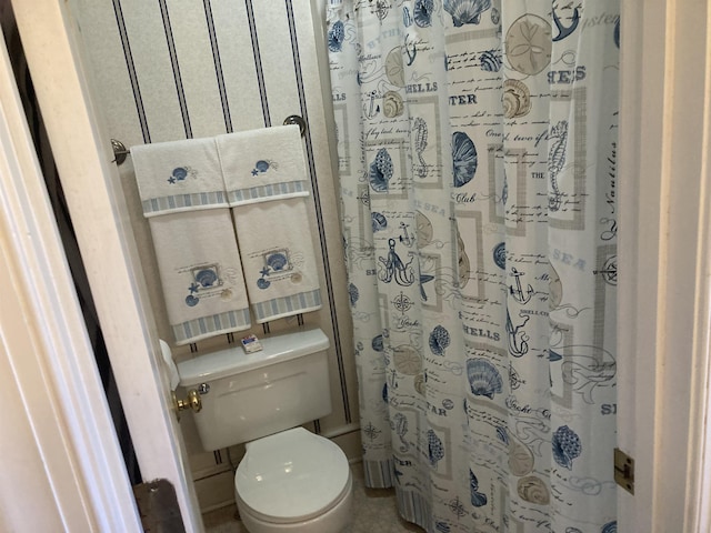 bathroom with toilet and curtained shower