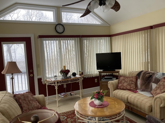 living area featuring lofted ceiling, plenty of natural light, and tile patterned floors