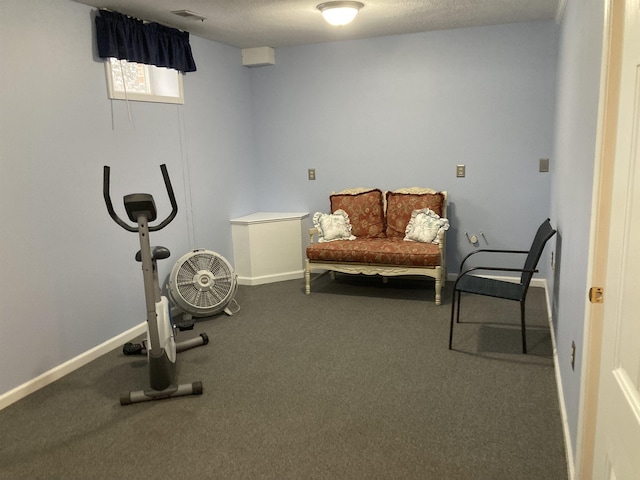 exercise area featuring visible vents and baseboards