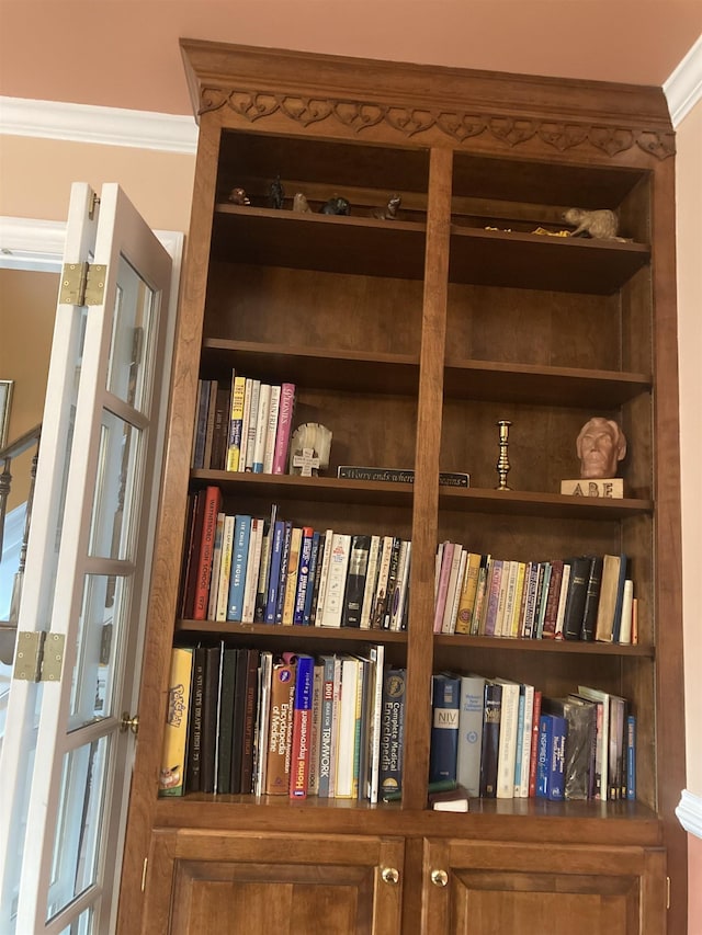 interior details featuring built in features and crown molding