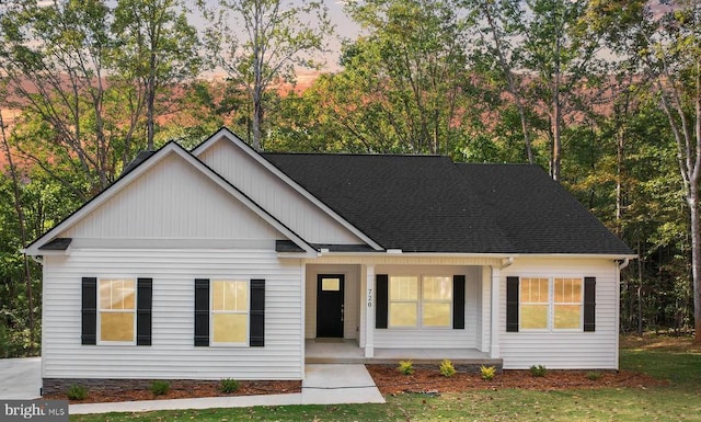 view of front of house with a porch and a shingled roof