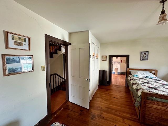 bedroom with dark hardwood / wood-style flooring