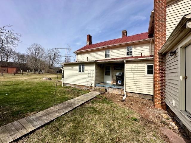 rear view of house with a yard