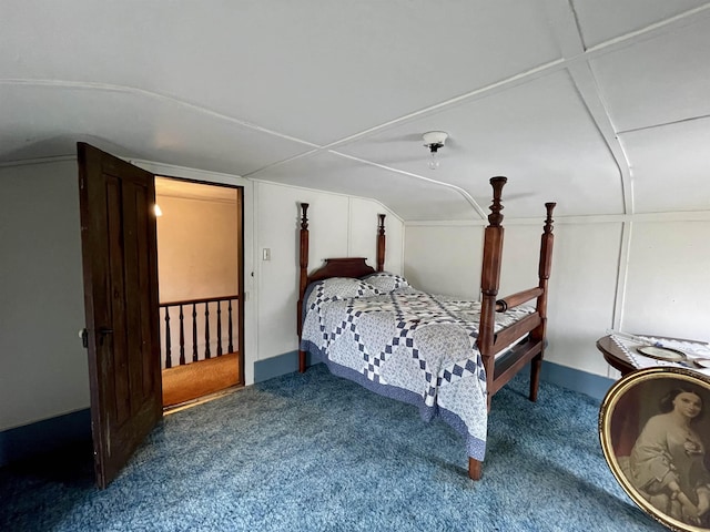 carpeted bedroom featuring lofted ceiling