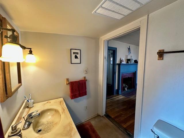 bathroom with vanity, hardwood / wood-style flooring, and toilet