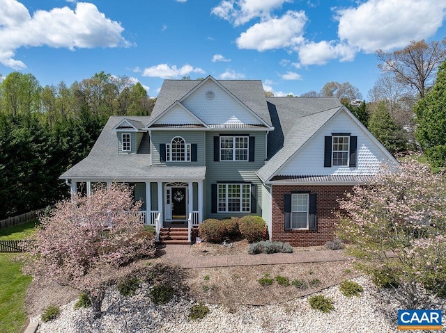 view of front of property with a porch and brick siding