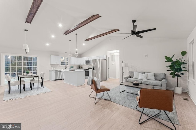 living area with baseboards, high vaulted ceiling, ceiling fan, light wood-style floors, and beamed ceiling