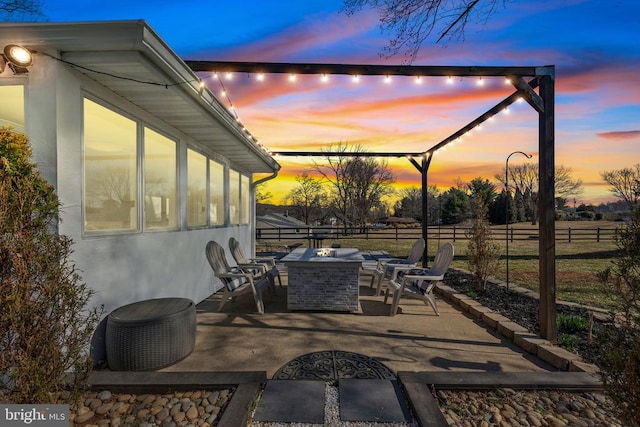 view of patio featuring an outdoor fire pit and fence