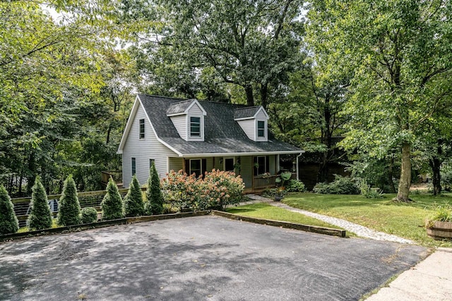 cape cod home featuring a porch and a front yard